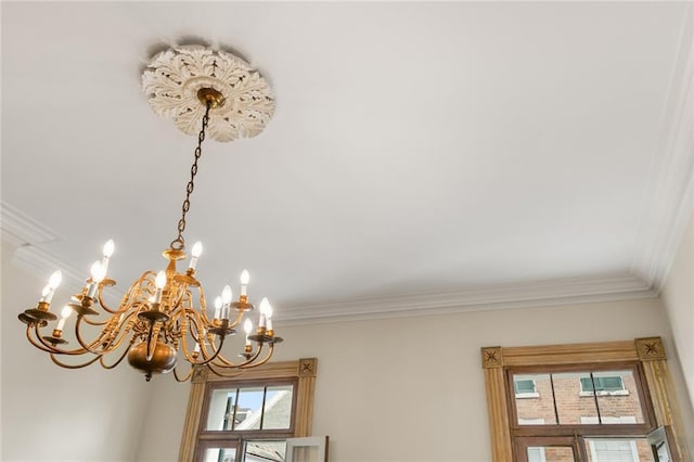 details with crown molding and an inviting chandelier