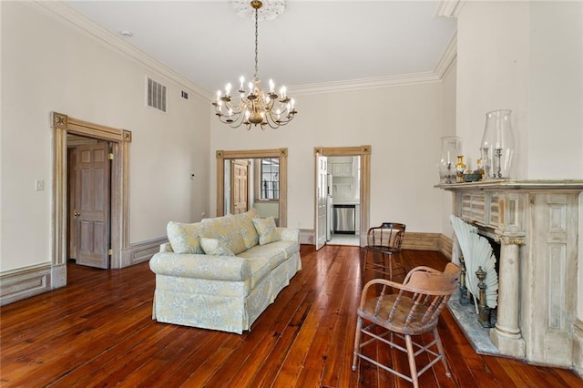 living room featuring ornamental molding, dark hardwood / wood-style floors, and an inviting chandelier