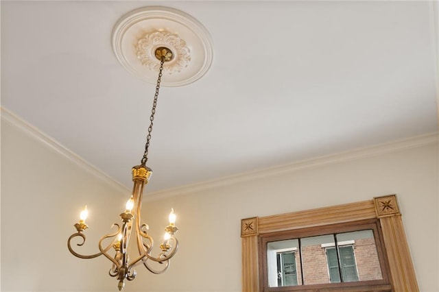 room details with ornamental molding and an inviting chandelier