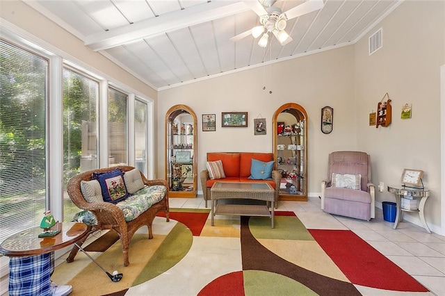 sunroom featuring ceiling fan and vaulted ceiling with beams