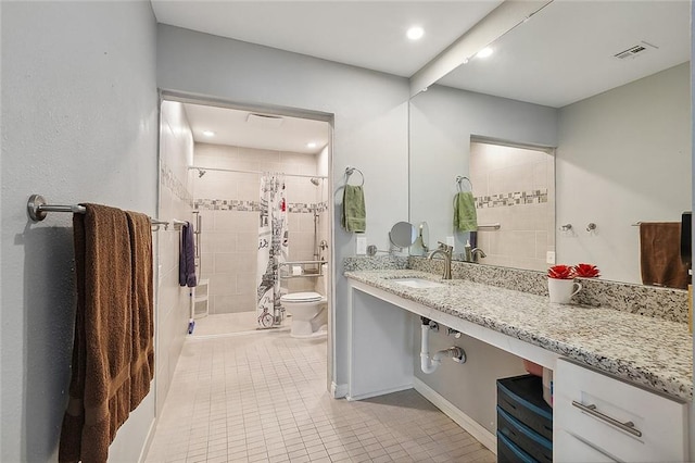 bathroom featuring toilet, tile flooring, curtained shower, and vanity