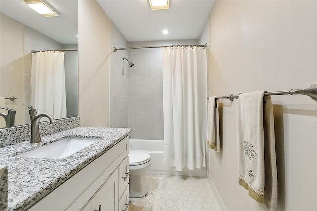 full bathroom featuring tile floors, toilet, oversized vanity, and shower / tub combo