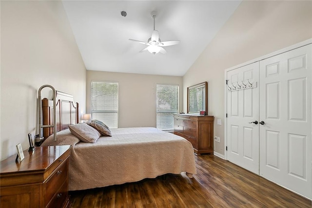 bedroom with dark hardwood / wood-style flooring, ceiling fan, a closet, and high vaulted ceiling