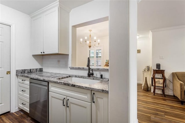 kitchen featuring stainless steel dishwasher, an inviting chandelier, white cabinetry, dark hardwood / wood-style flooring, and sink