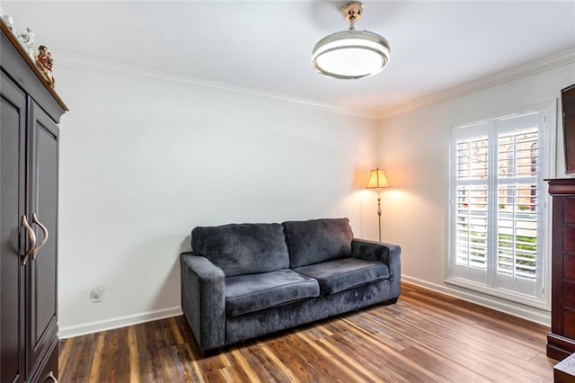 living room with dark wood-type flooring and ornamental molding