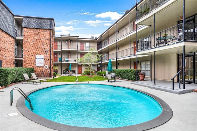 view of swimming pool with a patio area