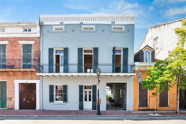 back of property with a balcony