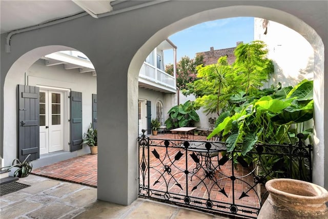 view of patio / terrace featuring a balcony and french doors