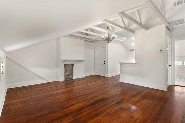 unfurnished living room featuring a notable chandelier, dark hardwood / wood-style floors, a fireplace, and vaulted ceiling