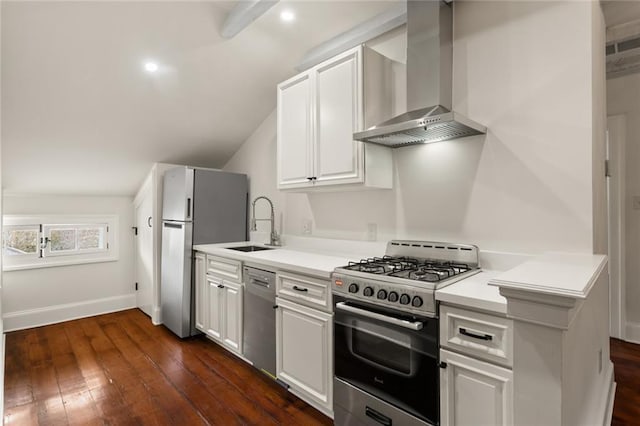 kitchen with white cabinetry, dark hardwood / wood-style flooring, wall chimney range hood, and appliances with stainless steel finishes