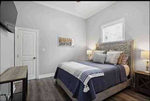 bedroom featuring lofted ceiling and dark hardwood / wood-style flooring