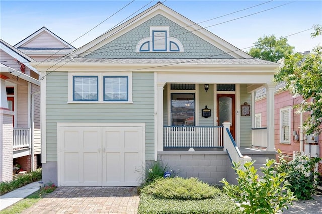 view of front of home featuring covered porch and a garage