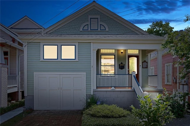 view of front facade with a porch and a garage