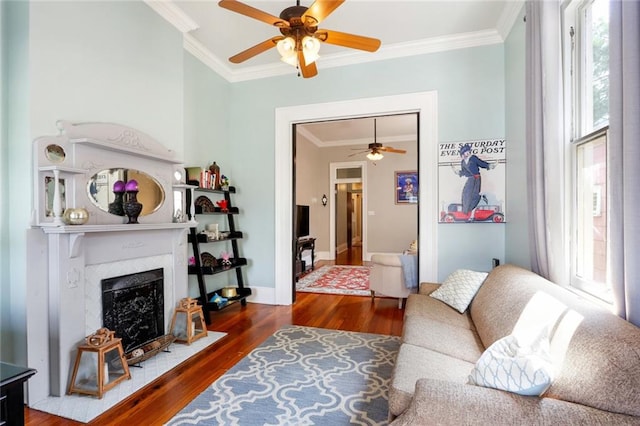 living room featuring ceiling fan, dark hardwood / wood-style flooring, and ornamental molding