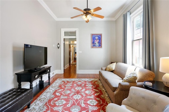 living room with ceiling fan, ornamental molding, and light hardwood / wood-style flooring