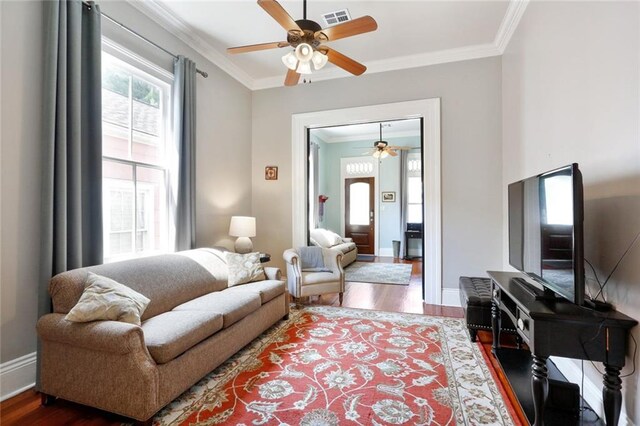 living room featuring ceiling fan, crown molding, and dark hardwood / wood-style floors