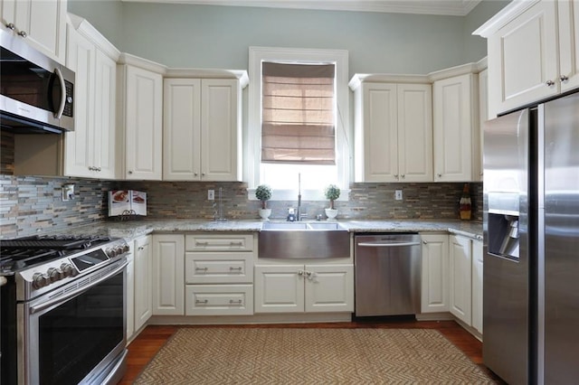 kitchen featuring sink, stainless steel appliances, backsplash, and dark hardwood / wood-style floors