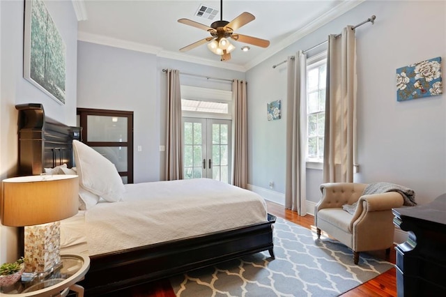 bedroom with dark hardwood / wood-style floors, multiple windows, and french doors