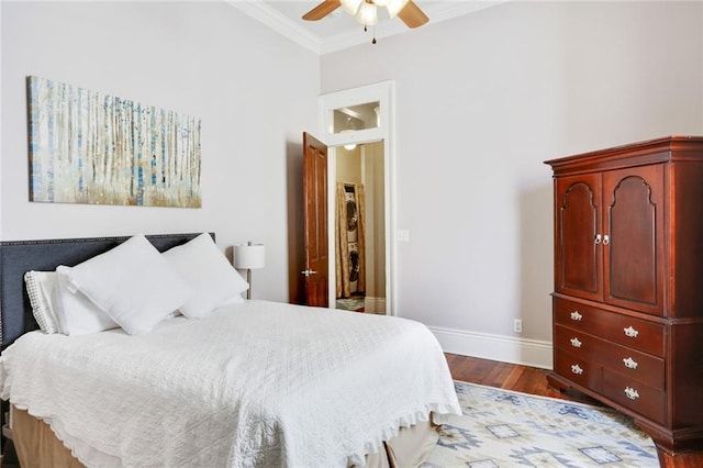 bedroom featuring dark hardwood / wood-style flooring, ceiling fan, and ornamental molding