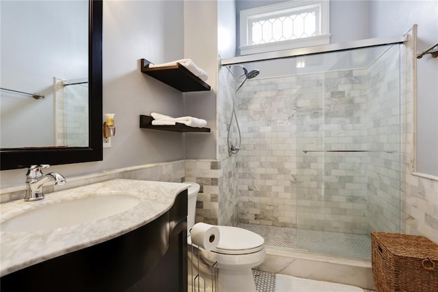 bathroom with vanity, walk in shower, tile flooring, and toilet