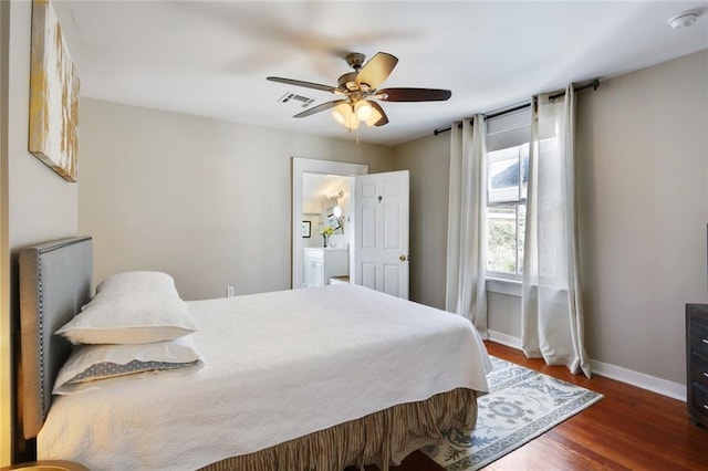 bedroom with dark hardwood / wood-style floors, ceiling fan, and ensuite bath