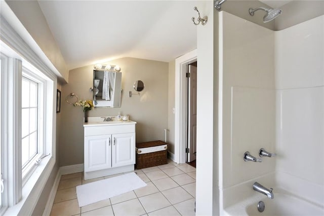 bathroom with lofted ceiling, shower / bathtub combination, tile floors, and vanity