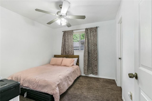 bedroom featuring ceiling fan and dark carpet