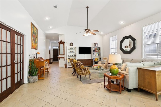 tiled living room featuring high vaulted ceiling, french doors, and ceiling fan