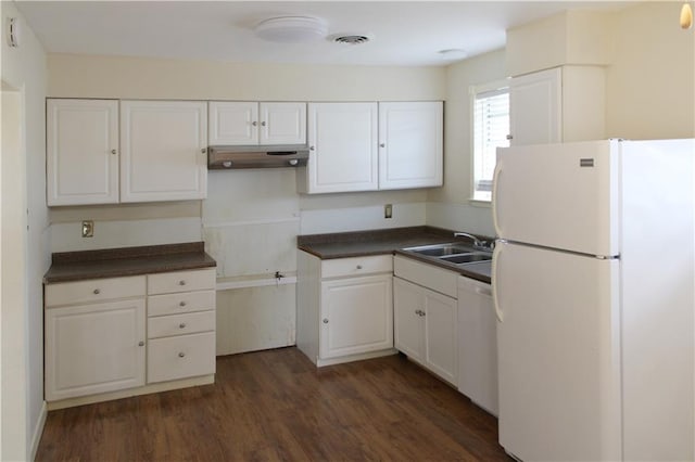 kitchen featuring sink, white cabinetry, white fridge, and dark wood-type flooring