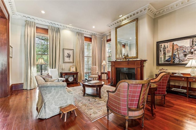 living area with crown molding and dark hardwood / wood-style floors