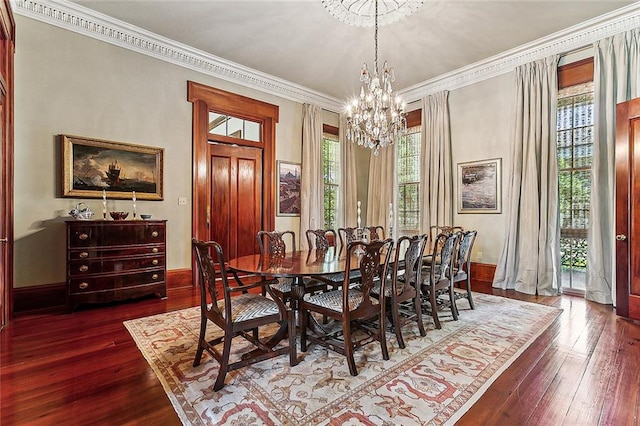 dining room featuring a chandelier, dark hardwood / wood-style floors, a healthy amount of sunlight, and ornamental molding