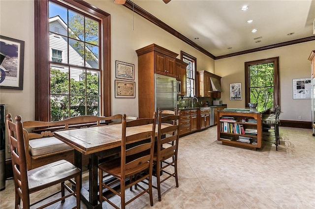 tiled dining room with ornamental molding and sink