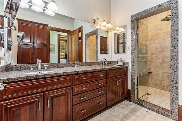 bathroom featuring dual sinks, tile floors, walk in shower, and vanity with extensive cabinet space