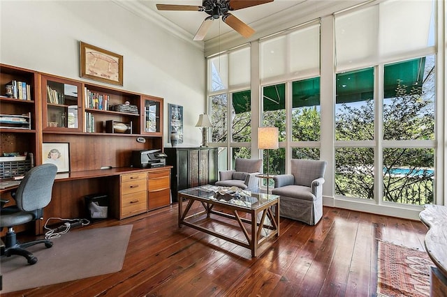 office with a high ceiling, ornamental molding, ceiling fan, and dark hardwood / wood-style floors