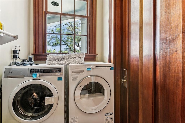 clothes washing area with independent washer and dryer