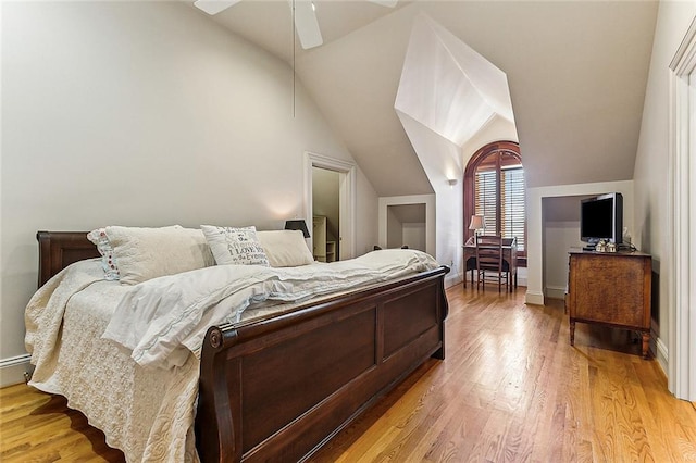 bedroom with light hardwood / wood-style floors, ceiling fan, and vaulted ceiling