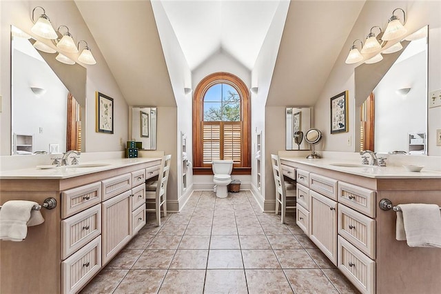 bathroom featuring lofted ceiling, tile flooring, and double sink vanity