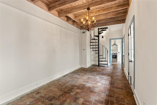 interior space featuring beam ceiling, wooden ceiling, and an inviting chandelier