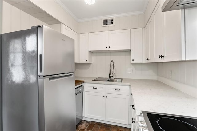 kitchen featuring light stone counters, stainless steel appliances, crown molding, sink, and white cabinetry