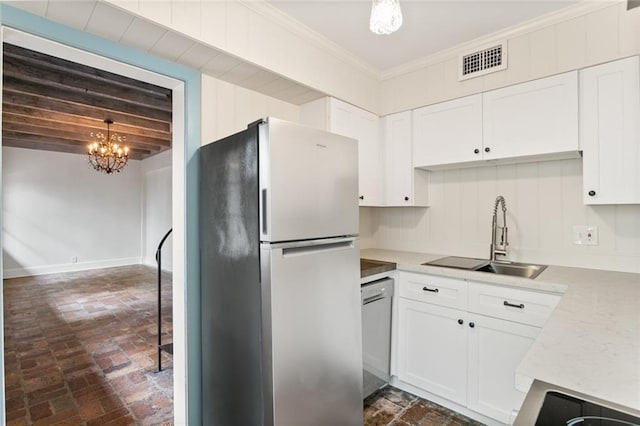 kitchen featuring white cabinetry, sink, pendant lighting, appliances with stainless steel finishes, and ornamental molding