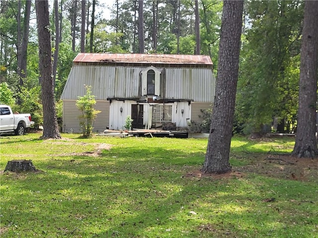 view of front of house with a deck and a front lawn