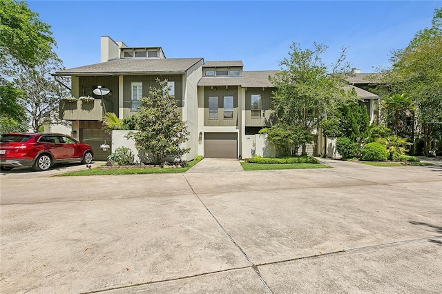 view of front facade with a garage and a balcony