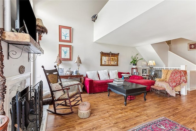 living room featuring light hardwood / wood-style floors and lofted ceiling