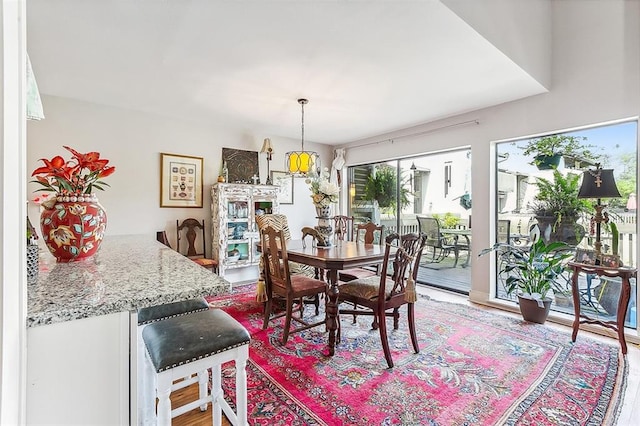 dining space with wood-type flooring