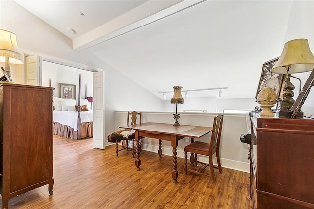 sitting room featuring hardwood / wood-style floors and lofted ceiling with beams