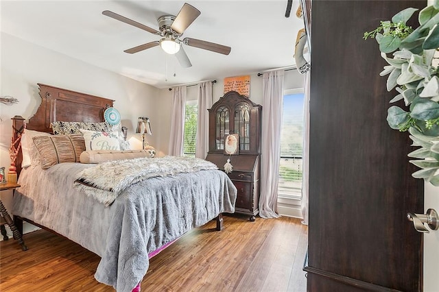 bedroom with ceiling fan and hardwood / wood-style flooring