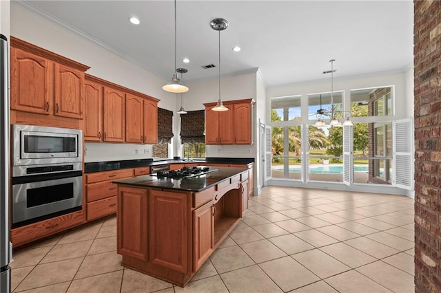 kitchen with light tile patterned floors, appliances with stainless steel finishes, brick wall, and crown molding