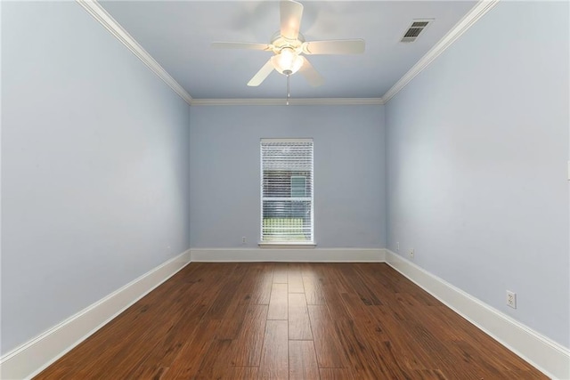 empty room with visible vents, ornamental molding, baseboards, and wood finished floors