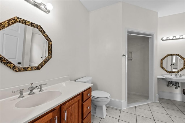 full bath with baseboards, a sink, walk in shower, tile patterned floors, and toilet