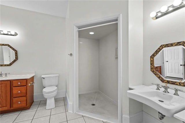 full bathroom featuring tile patterned floors, toilet, a stall shower, and a sink